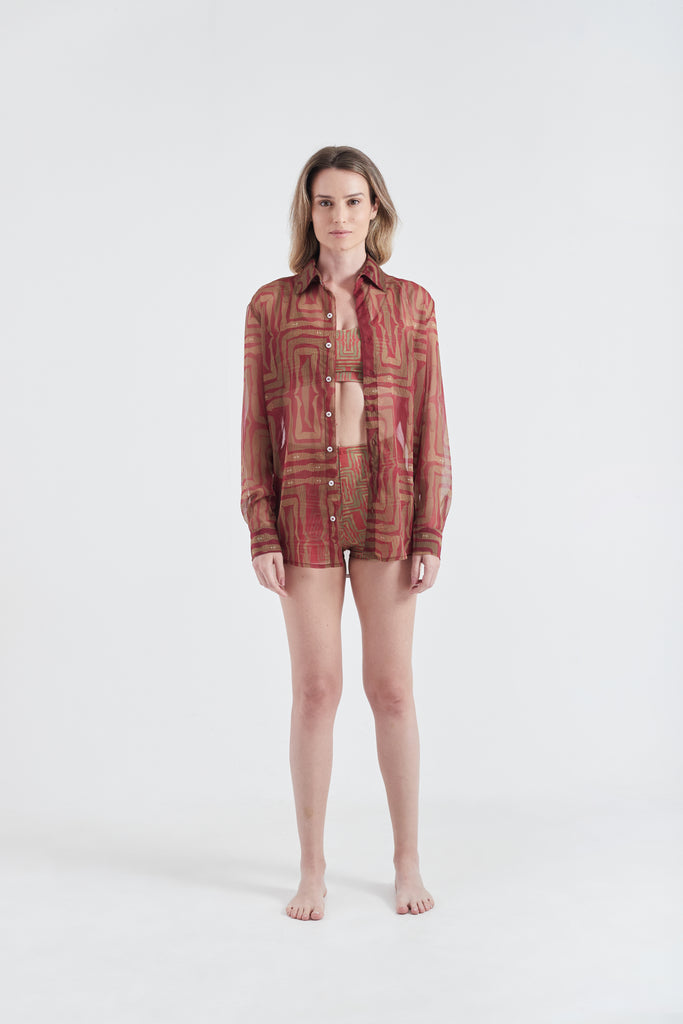 Modelo usando a Camisa Vermelho/Amarelo com estampa Mão na Perna, feita em tule.