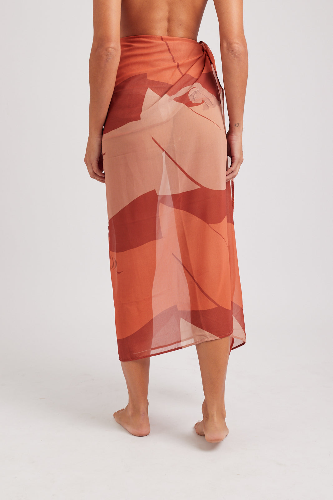 Modelo usando o pareô vermelho/creme Onda