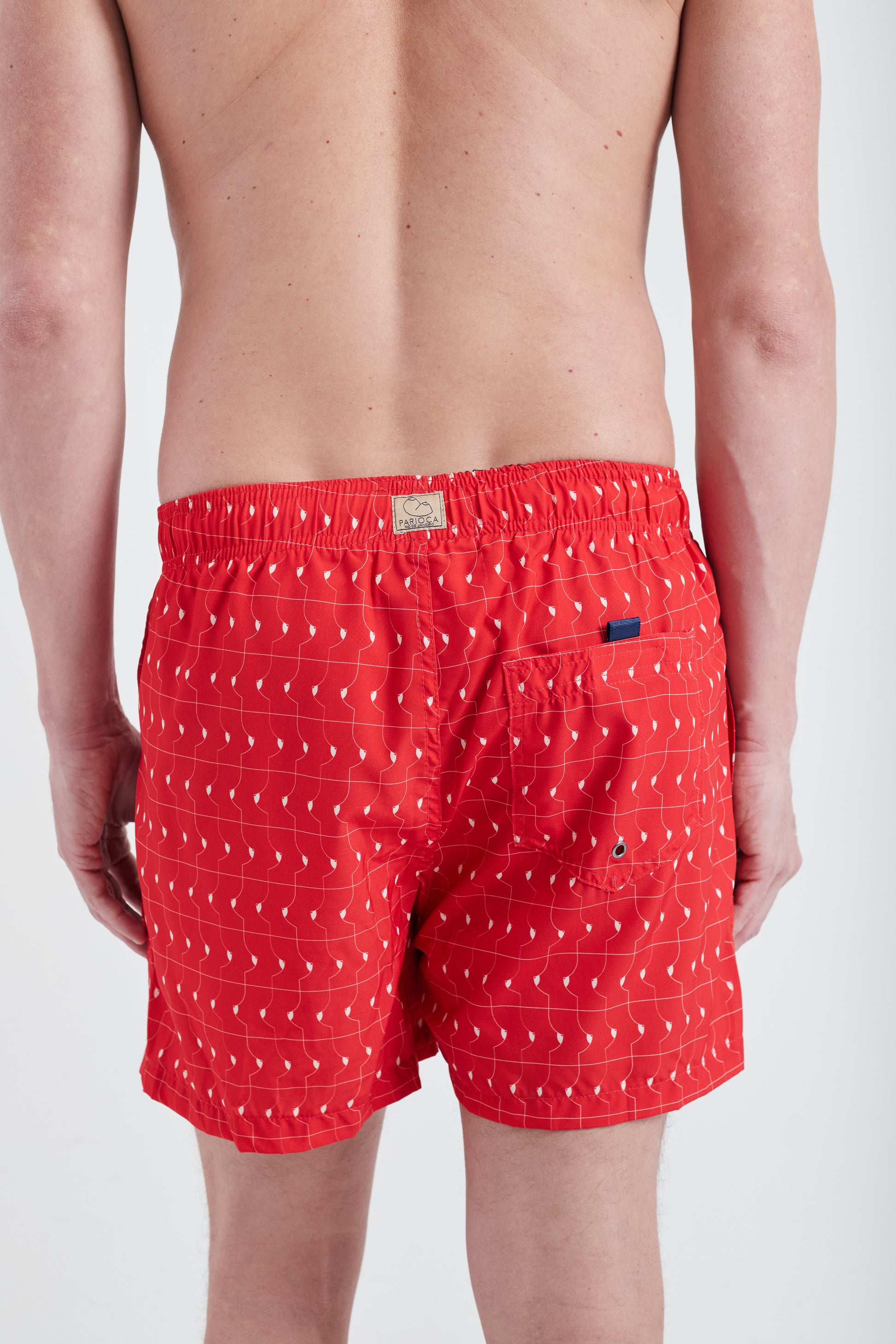 Modelo usando Shorts Boobie Trap Vermelho, vista traseira, mostrando ajuste e caimento perfeito.