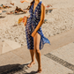 Modelo usando pareo Happy Oyster azul em cenário de praia